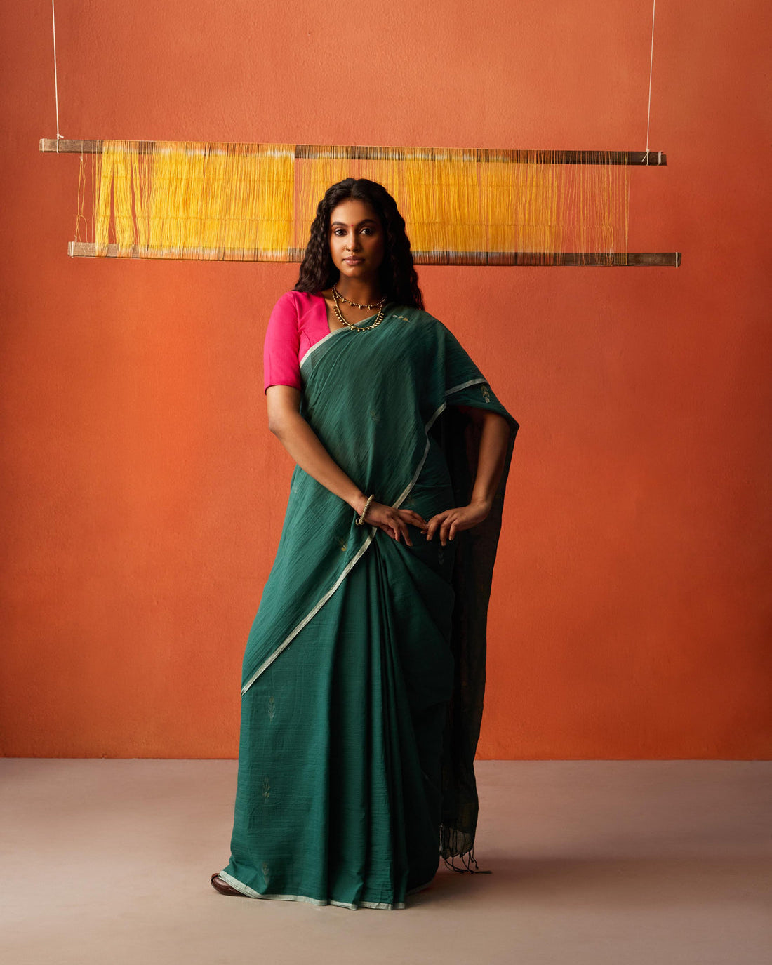 A woman wearing Green Cotton Jamdani Saree