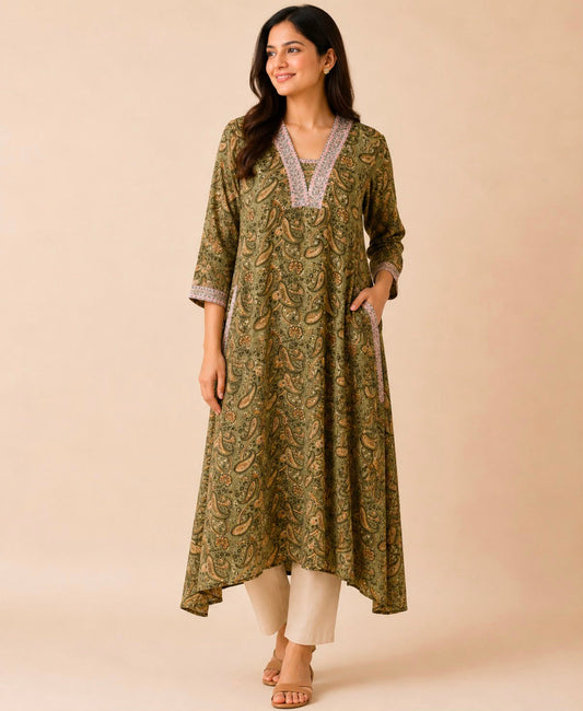 A woman modeling a long olive green printed kurta with a V-neck and light gray trim, paired with off-white pants, 